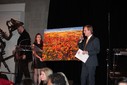 Joe Cressy, Director of Campaigns and Community Outreach at the Stephen Lewis Foundation, auctions a Bev Jenkins painting.